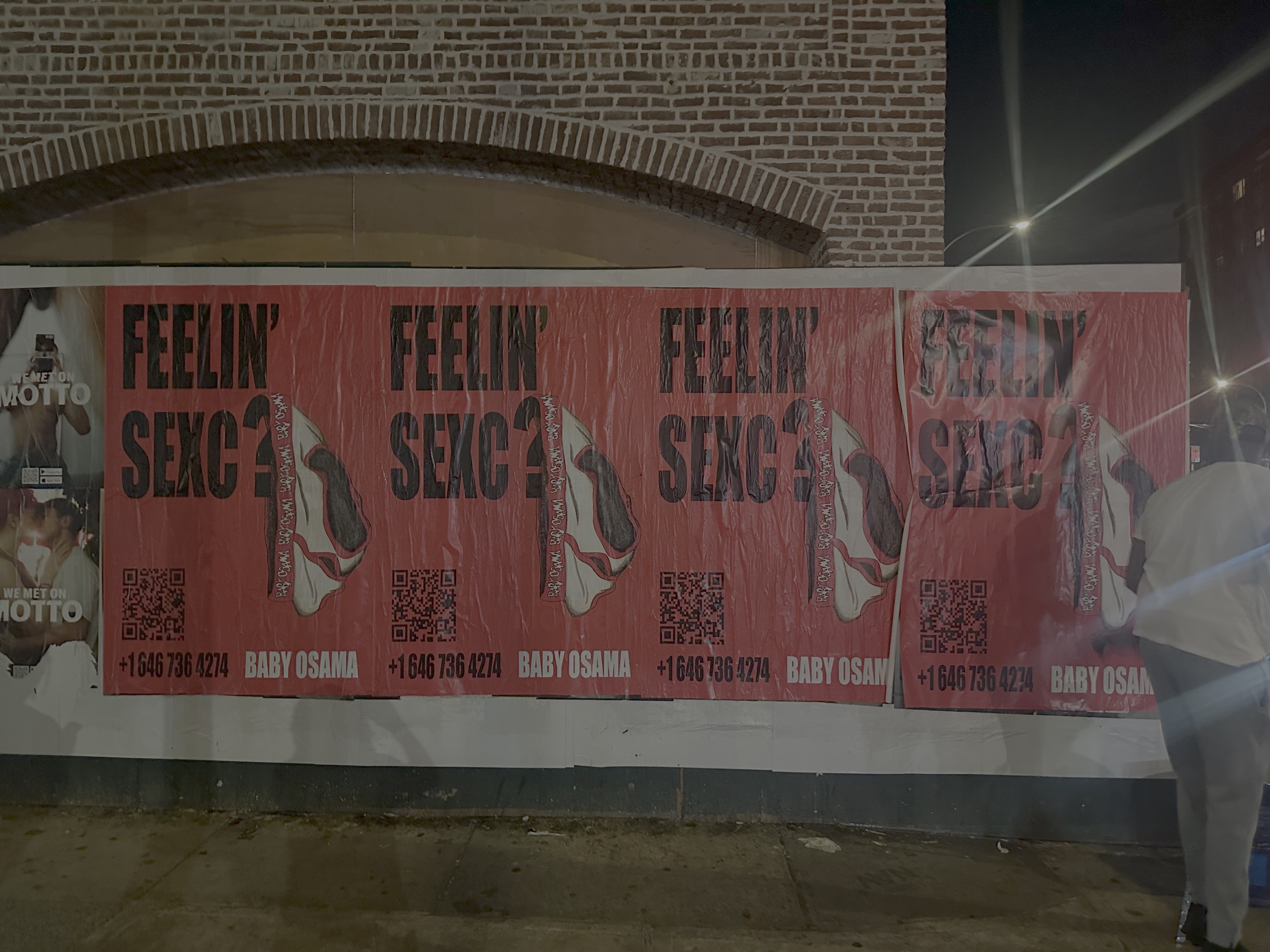 FEELIN SEXC wheat-paste campaign installed on a New York City wall at night